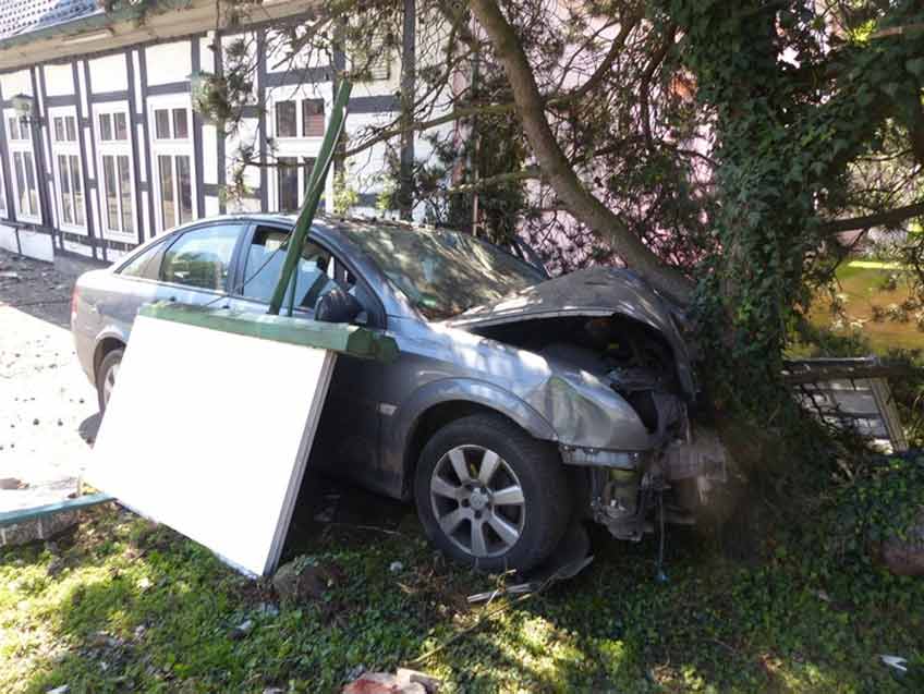 Pkw durchfährt Hausvorbau und prallt gegen Bau Der Wagen kam erst an einem Baum zum Stehen.